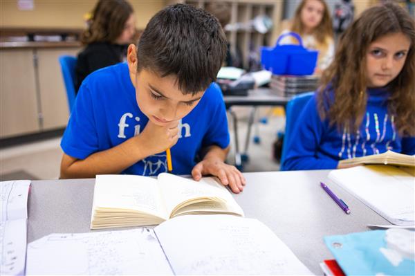 Students inside their classrooms learning. 